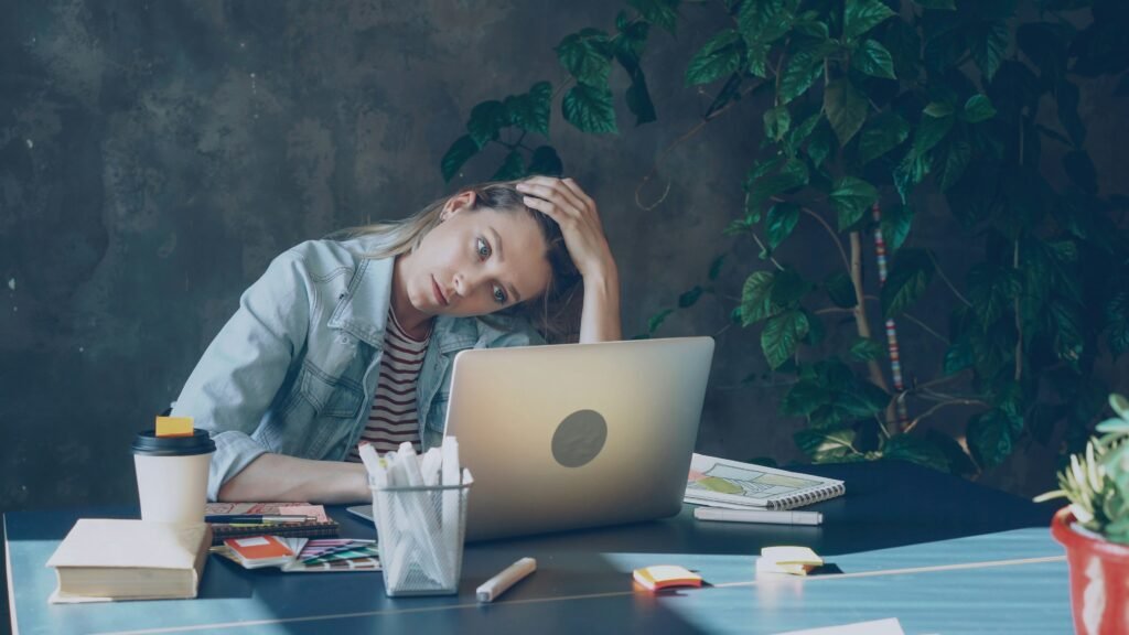 Busy woman experiencing stress and mental fatigue while working.