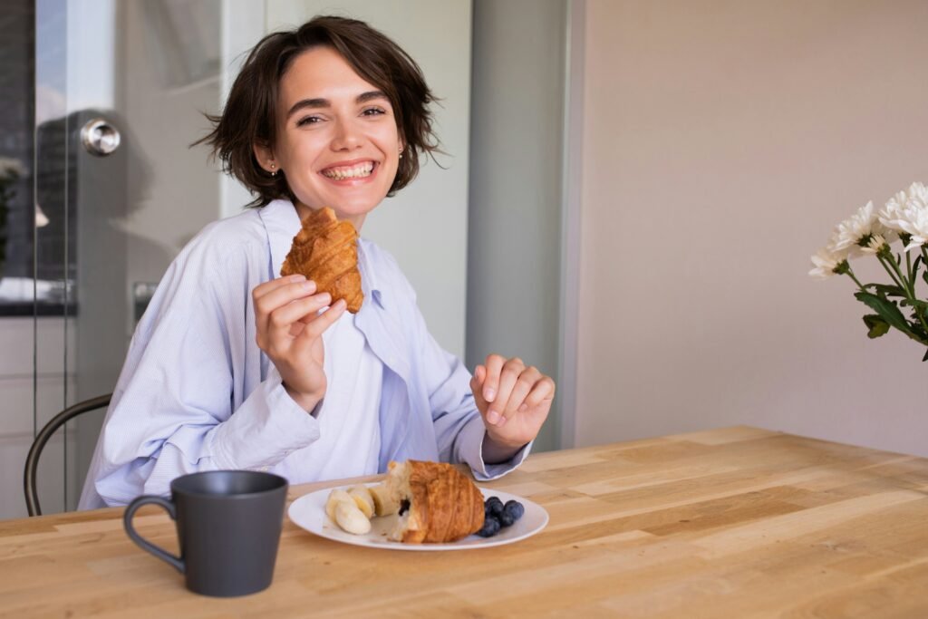 Woman enjoying food without guilt as part of a balanced lifestyle.