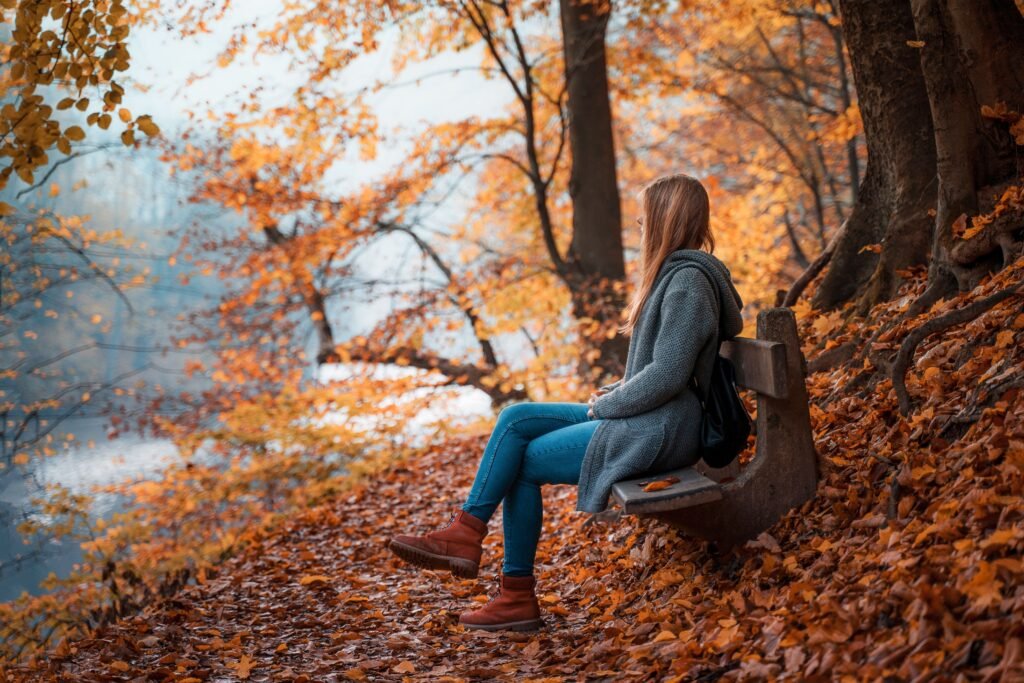 Woman calming her nervous system through relaxation and mindfulness outdoors.