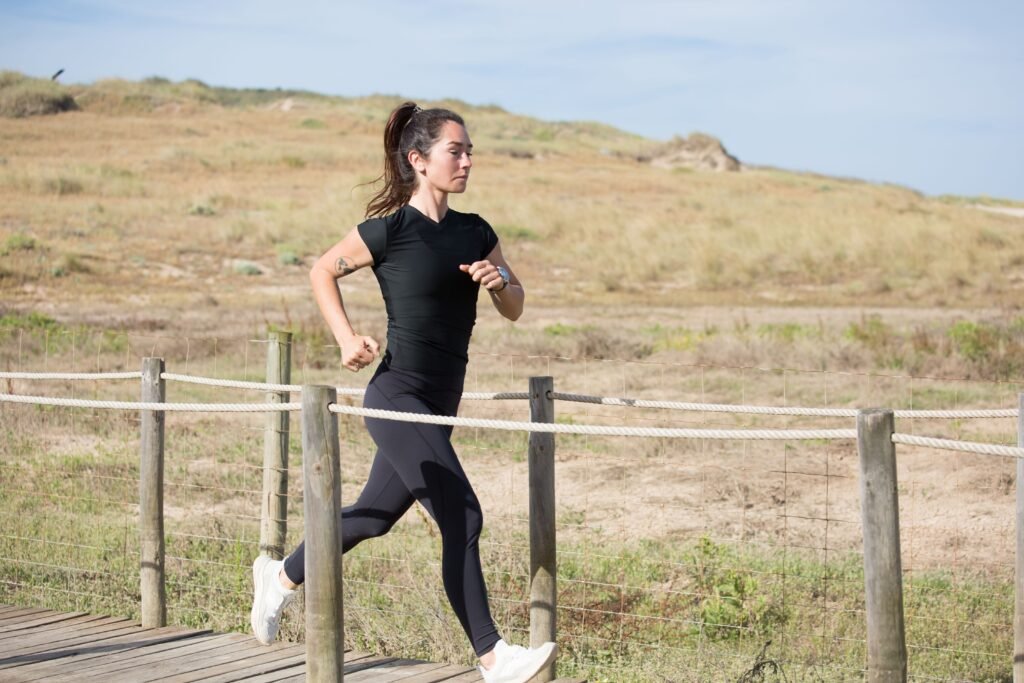 Woman jogging confidently outdoors as part of a healthy lifestyle.