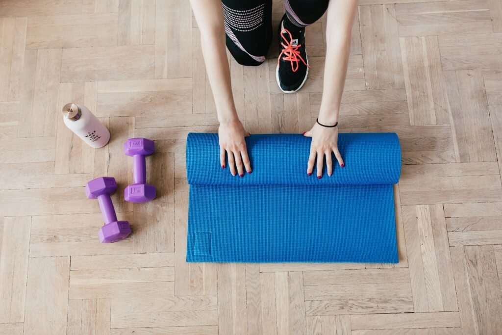 Weights and water bottle ready to use by yoga mat